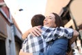 Joyful couple hugging in the street after meeting