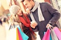 Joyful couple shopping in the city with smartphone Royalty Free Stock Photo
