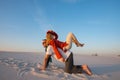 Joyful crazy couple of travelers fools around and has fun in desert