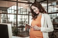 Joyful dark-haired pregnant woman being extremely sentimental