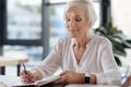 Joyful delighted woman writing memoirs Royalty Free Stock Photo