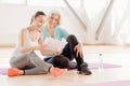 Joyful delighted women reading the workout plan