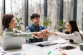 Joyful Diverse Coworkers Celebrating Success Uniting Stacked Hands In Office