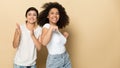 Joyful diverse multicultural female friends dancing together.