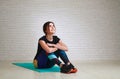 Joyful dreaming woman after fitness yoga exercises looking up