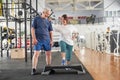 Joyful elederly couple at modern gym.