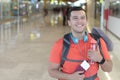 Joyful ethnic man smiling during trip