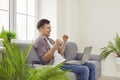 Joyful excited guy with laptop rejoices in success, victory, good profit or new job.