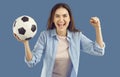 Joyful excited woman with soccer ball in her hand is crazy happy after winning bet. Royalty Free Stock Photo