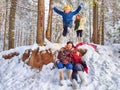 Joyful family ethnic dress with shawls and earflap hats in a winter forest in carnival Maslenitsa in Russia. Tourists in