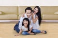 Joyful family playing together on the floor Royalty Free Stock Photo