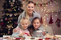 Joyful family preparing Christmas biscuits Royalty Free Stock Photo