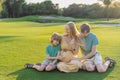 Joyful family time as a pregnant woman, her husband, and son share quality moments outdoors, embracing the beauty of Royalty Free Stock Photo