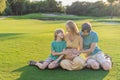 Joyful family time as a pregnant woman, her husband, and son share quality moments outdoors, embracing the beauty of Royalty Free Stock Photo