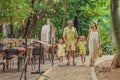 A joyful family, two girls, dad, and a pregnant mom, bask in tropical resort, celebrating a radiant pregnancy amidst