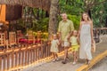 A joyful family, two girls, dad, and a pregnant mom, bask in tropical resort, celebrating a radiant pregnancy amidst