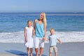 Joyful family walking on the beach