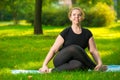 joyful fat woman doing yoga outdoors
