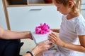 Smiling Father and Daughter Sharing a Gift Box With a Pink Bow Indoors