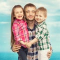 Joyful father hugging his son and daughter Royalty Free Stock Photo