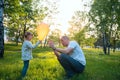 Joyful father plays with small daughter on a green meadow Royalty Free Stock Photo