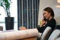 Joyful female architect having phone conversation in her office