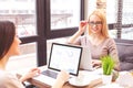 Joyful female colleagues using computers Royalty Free Stock Photo