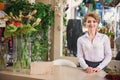 Joyful female florist greeting new client