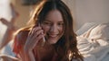 Joyful female talking mobile phone in sunlight closeup. Smiling girl at home Royalty Free Stock Photo