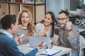 Joyful four colleagues brainstorming