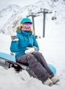 Young woman snowboarder in mountains Royalty Free Stock Photo