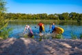 Joyful friends with SUP boards in their hands run out of the water Royalty Free Stock Photo