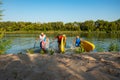 Joyful friends with SUP boards in their hands run out of the water Royalty Free Stock Photo