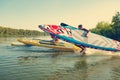 Joyful friends with SUP boards in their hands run to the water Royalty Free Stock Photo