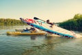 Joyful friends with SUP boards in their hands run to the water Royalty Free Stock Photo