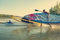 Joyful friends with SUP boards run to the water Royalty Free Stock Photo