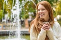 Joyful girl drinking coffee outdoors