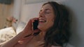 Joyful girl enjoying phone conversation closeup. Relaxed woman lying home bed