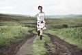 Joyful girl running on a countryside road Royalty Free Stock Photo