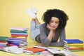 Joyful girl studying surrounded by colorful books. Royalty Free Stock Photo