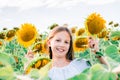 Joyful girl with sunflowers in the field in the sun. Local tourism and freedom Royalty Free Stock Photo