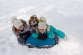 Joyful girls ride a tubing from a hill together. Winter holiday