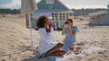 Joyful girls taking pictures on sandy beach. Happy lgbt couple enjoying vacation Royalty Free Stock Photo