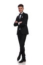 Joyful groom standing with arms and legs crossed Royalty Free Stock Photo