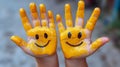 Joyful Hands with Yellow Paint and Smiling Faces Royalty Free Stock Photo
