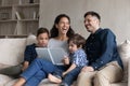 Joyful happy family laughing at funny story, reading book. Royalty Free Stock Photo