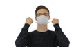 Joyful happy man taking off his protective mask The coronavirus pandemic epidemic is over on white background.