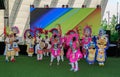 joyful, happy people in bright colorful costumes dancing near the stage Royalty Free Stock Photo