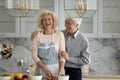 Joyful happy retired couple cooking in home kitchen together Royalty Free Stock Photo