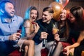 Joyful happy young people have party in karaoke bar Royalty Free Stock Photo